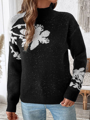 Black mock neck knit sweater with white floral embellishments and subtle sparkle detail.