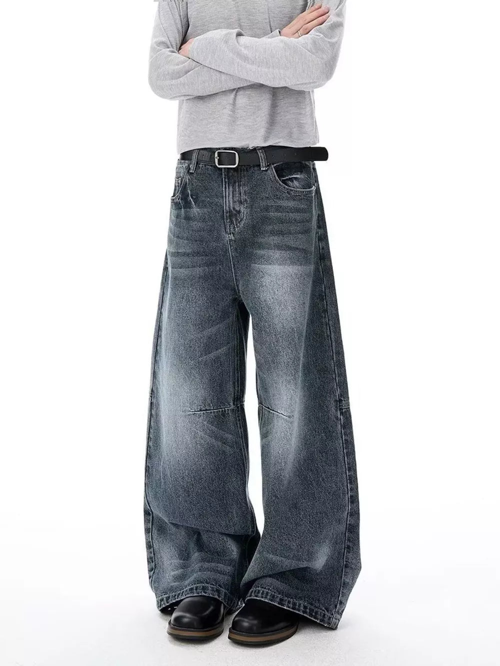 Men's dark wash wide-leg jeans with a belted waist and vintage-inspired details.