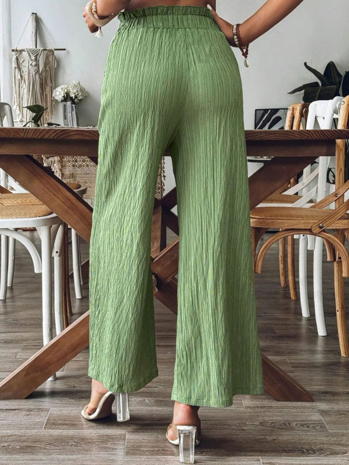 Textured wide-leg palazzo trousers in matcha green with a crinkled fabric and paperbag waist.