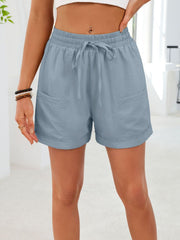 Blue casual shorts with elastic waist, drawstring, and pockets.