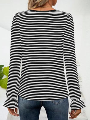 Black and white striped blouse with ruffle cuffs and long sleeves.