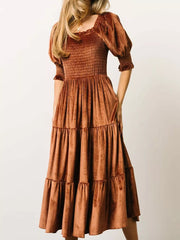 Velvet smocked midi dress in caramel with ruffled puff sleeves and tiered skirt.