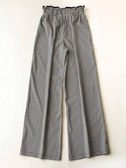 High-waisted wide-leg gingham pants with a ruffled black waistband.