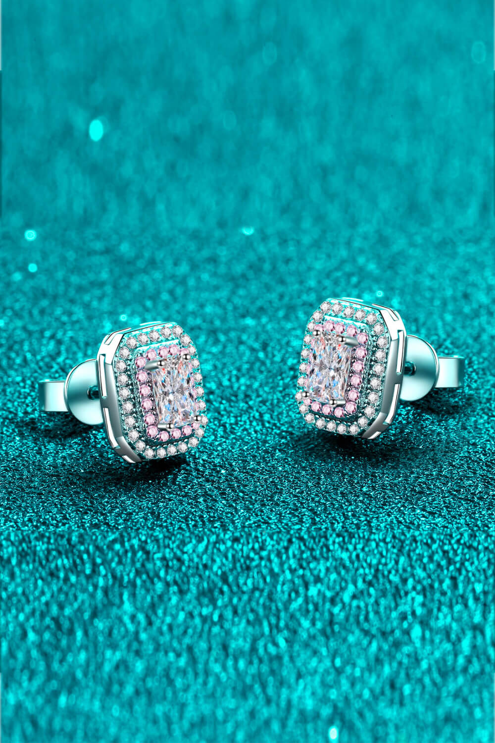 Radiant Emerald-Cut Halo Studs in silver with pink and clear accents.