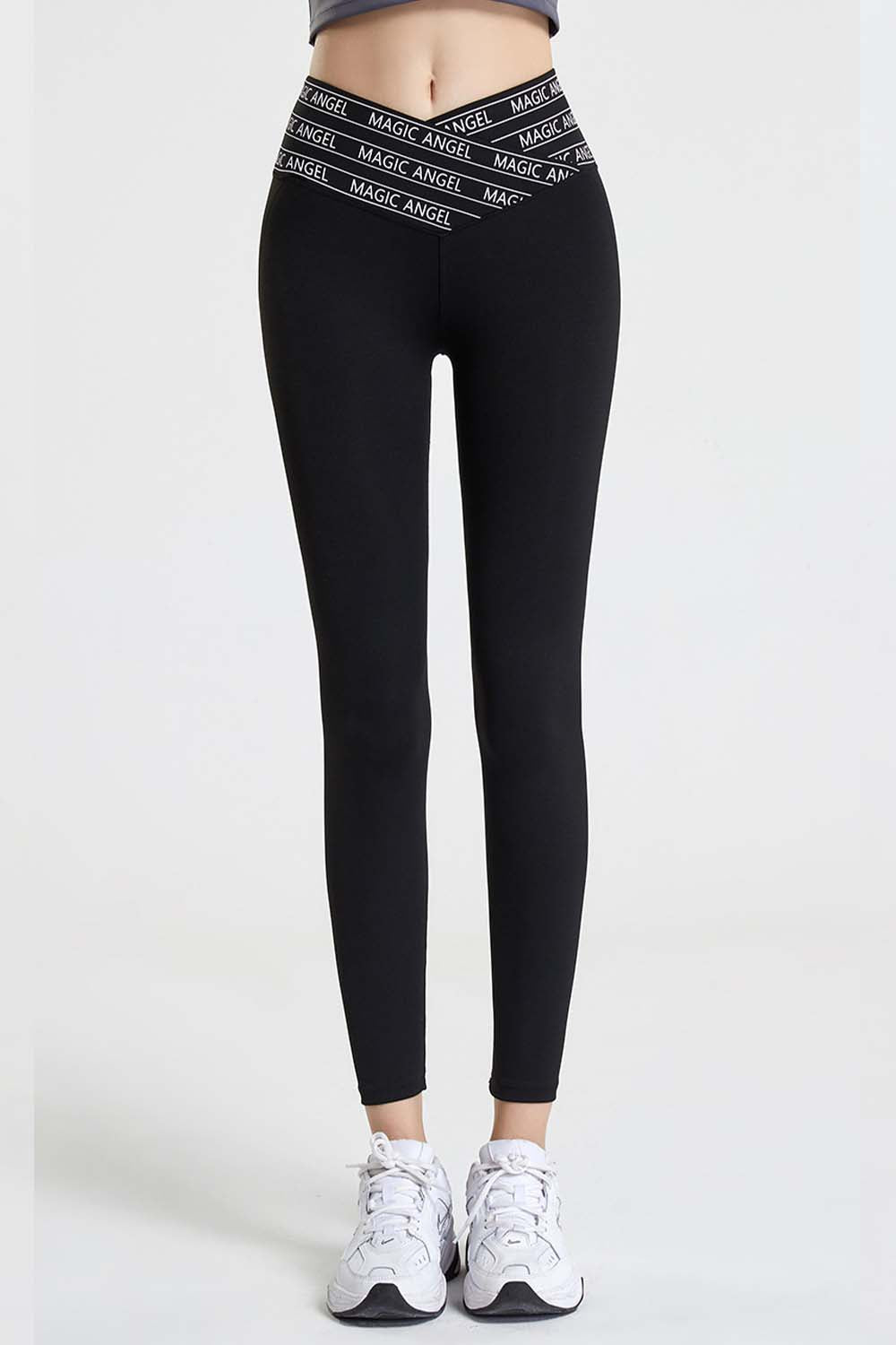 Black active leggings with a white logo waistband and a V-cut front.