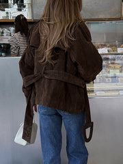 Brown belted trench coat with lapel collar and tie waist detail.