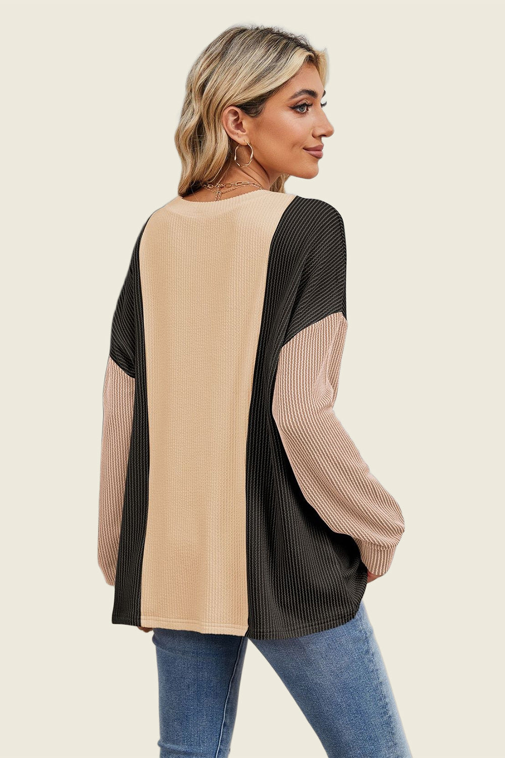 Colorblock waffle knit pullover sweater in tan, black, and dusty pink with long sleeves.