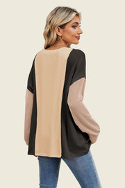 Colorblock waffle knit pullover sweater in tan, black, and dusty pink with long sleeves.