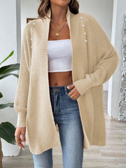Tan ribbed knit cardigan with pearl buttons, open front, long sleeves.
