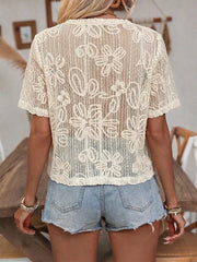 Apricot lace tie-front shirt with floral cutout detail and short sleeves.