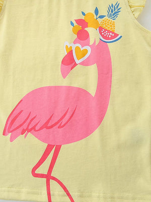 Yellow cotton baby top with a pink flamingo graphic wearing heart sunglasses and fruit hat.