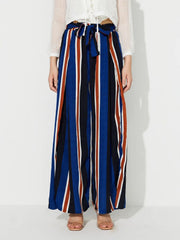Striped palazzo trousers with side slits and a tie waist in blue, black, white, and rust stripes.