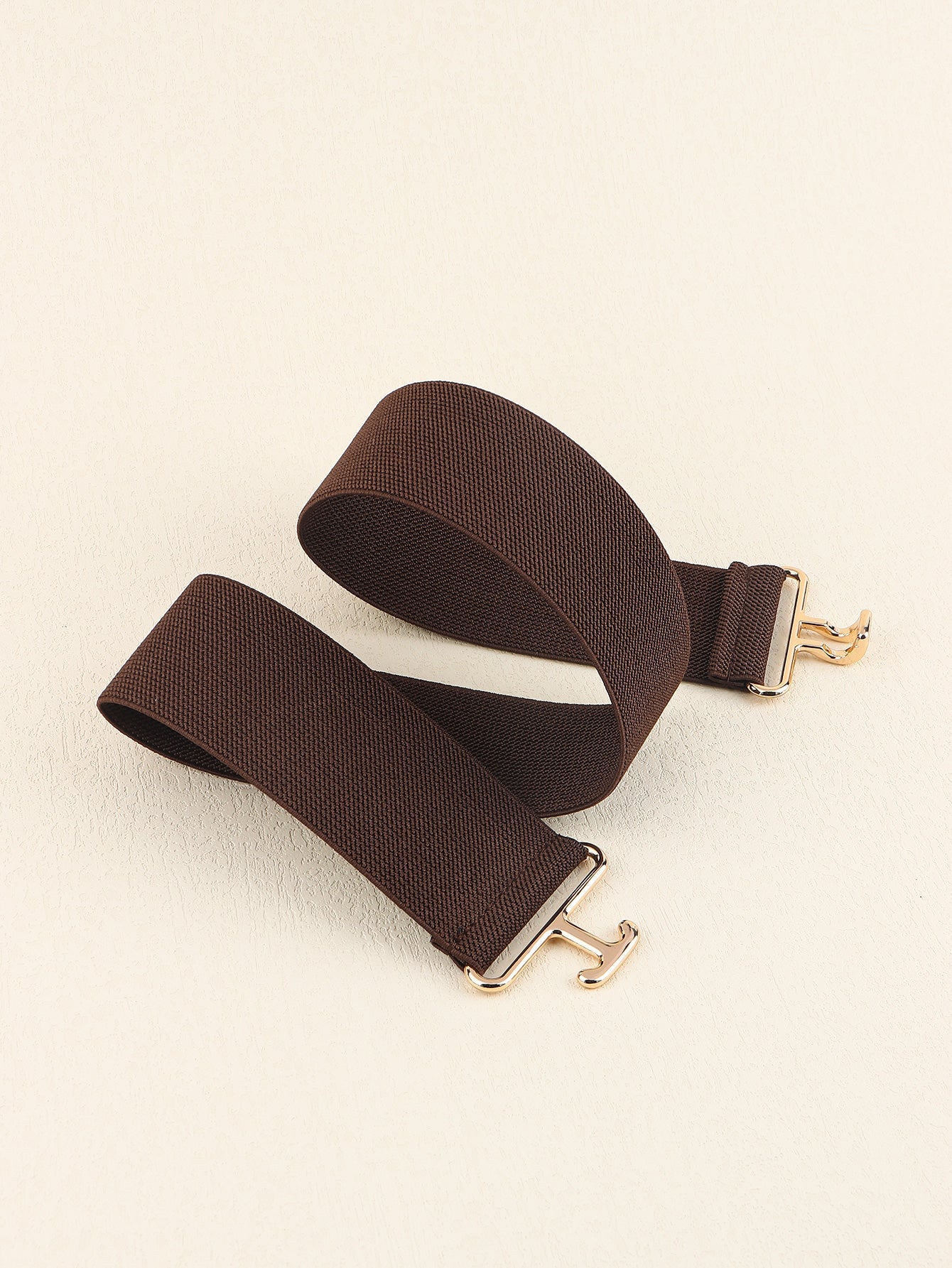Chocolate elastic belt with sculpted gold buckle detail