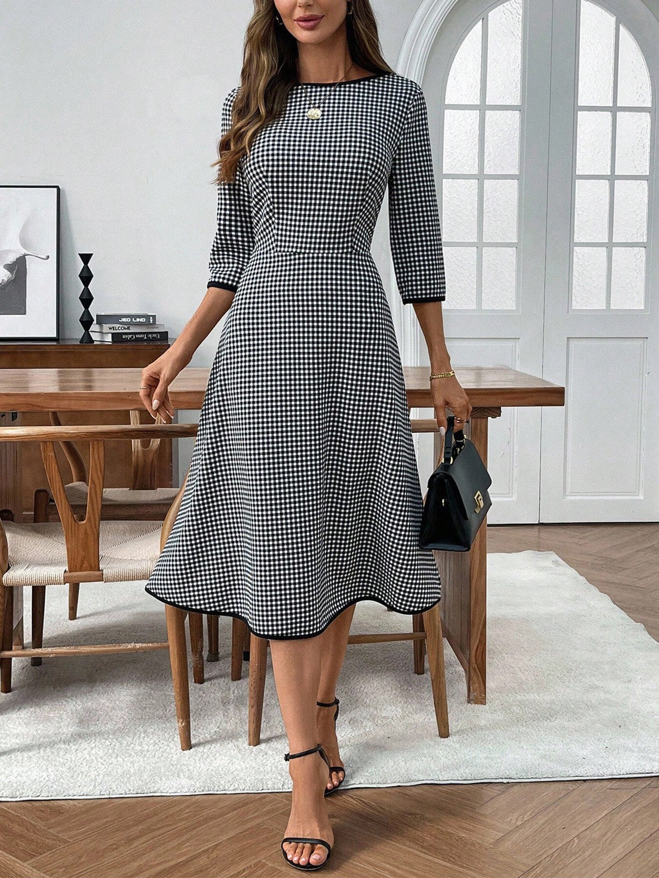 Black and white gingham midi dress with 3/4 sleeves, A-line cut, and crew neck.
