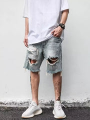Men's light blue distressed denim shorts with rips and frayed hem.