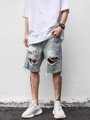 Men's light blue distressed denim shorts with rips and frayed hem.