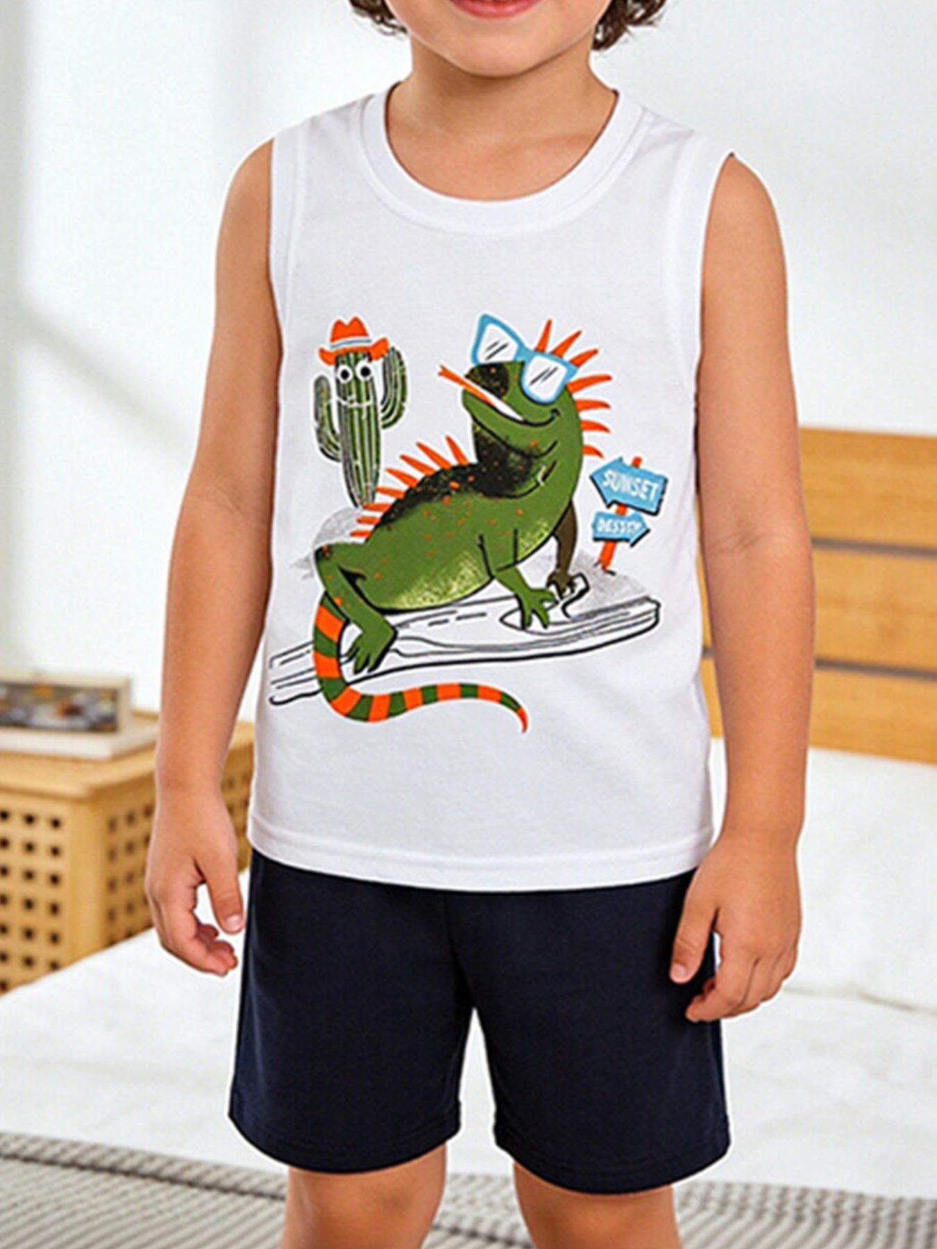 White cotton toddler tank top with lizard graphic and navy shorts.