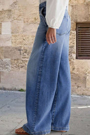 Light wash denim jeans with subtle stitching detail and a wide-leg cut.