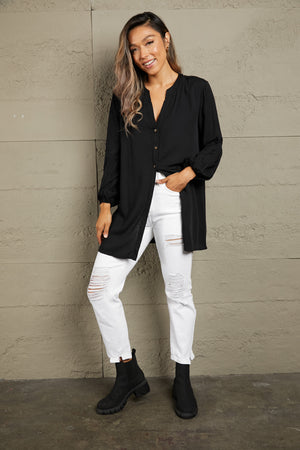Black oversized mandarin collar blouse with button front and balloon sleeves.