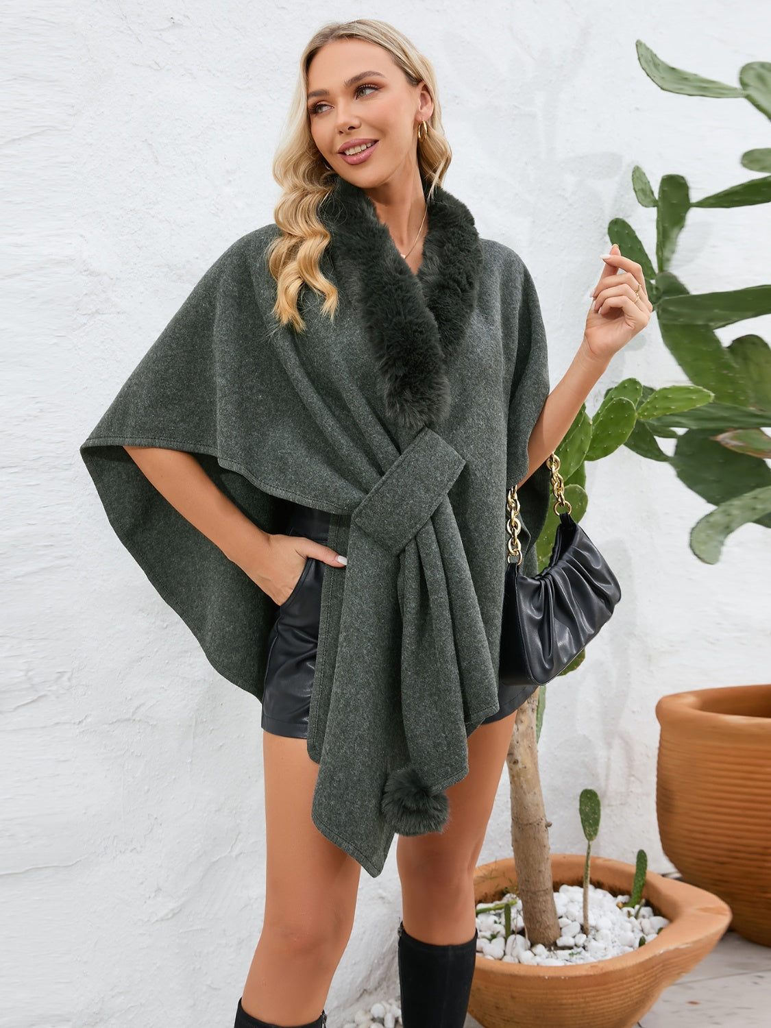 Dark green faux fur collar wrap poncho with tie belt and pom-pom detail.