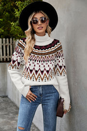 Geometric knit turtleneck sweater in white with burgundy and brown pattern.