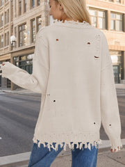 Cream knit sweater with frayed details and distressed holes, crew neck, long sleeves.