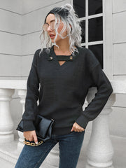 Black acrylic sweater with V-neck, keyhole detail and button accents.