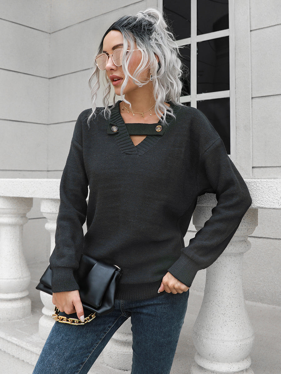 Black acrylic sweater with V-neck, keyhole detail and button accents.
