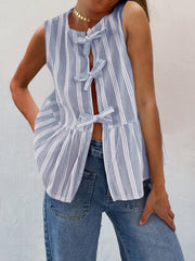 Light blue and white striped peplum top with bow tie closures and a ruffled hem.