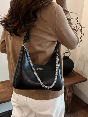 Black leather crossbody bag with silver chain detail and logo accent