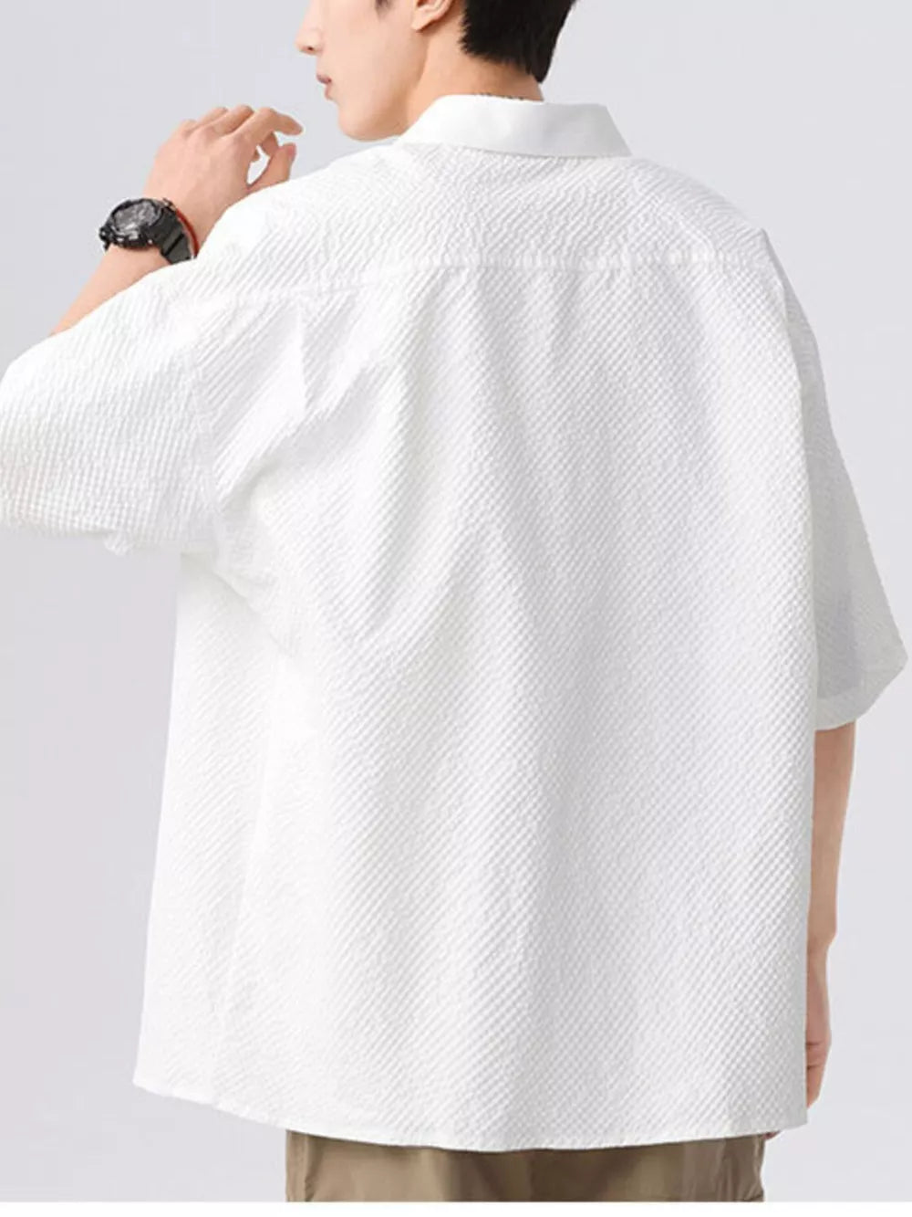 Men's white textured short-sleeve shirt with a collared neckline.