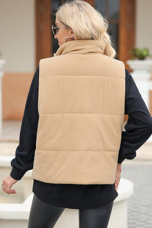 Tan corduroy padded funnel neck vest with horizontal quilting detail.