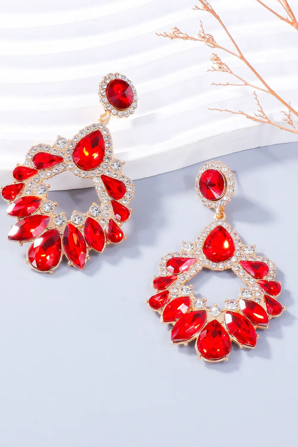Red crystal drop earrings with gold alloy setting and floral-inspired design