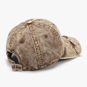 Acid wash distressed baseball cap in tan with frayed brim detail.