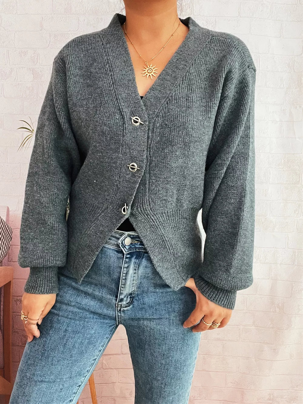 Gray ribbed V-neck button-through cardigan with silver hardware details.