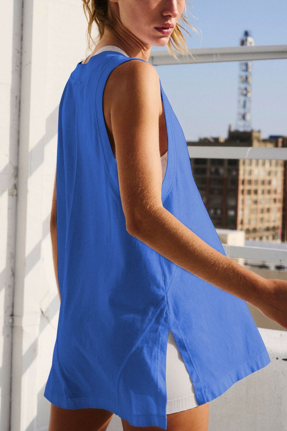Blue oversized V-neck tank top with side slits and a relaxed fit.