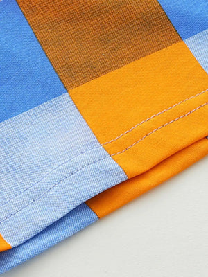 Baby cotton tee and shorts set with blue and orange plaid pattern and stitched hem detail.