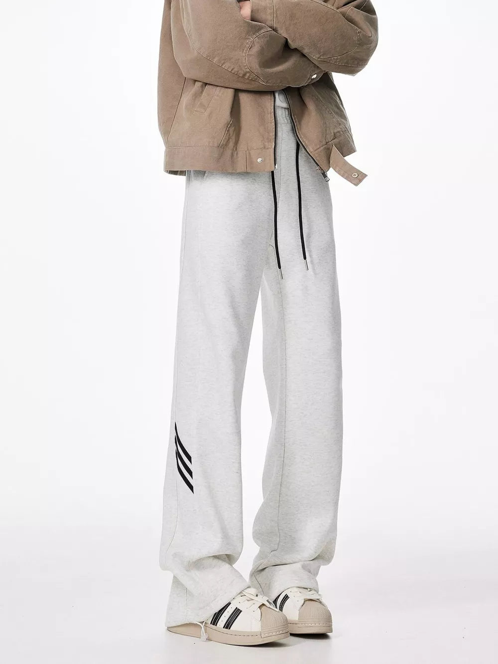 Light gray sweatpants with drawstring and black stripe detail on leg