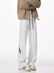 Light gray sweatpants with drawstring and black stripe detail on leg