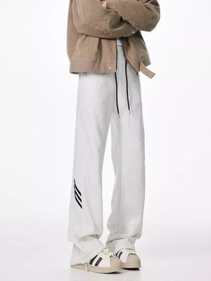 Light gray sweatpants with drawstring and black stripe detail on leg