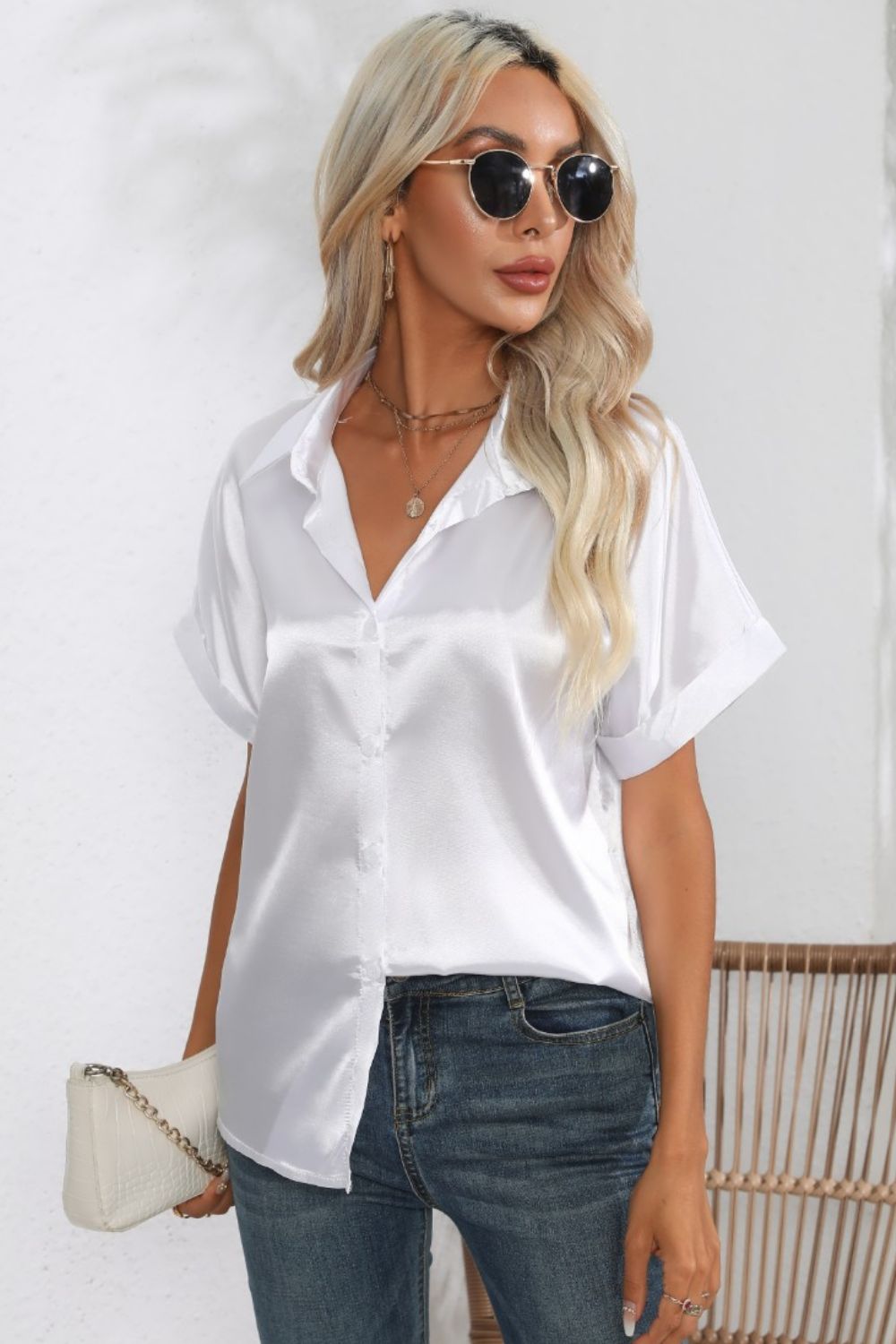 White satin button-down blouse with cuffed short sleeves and a V-neck.