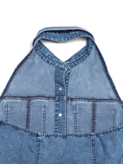 Button-front halter neck denim dress with contrast stitching and raw hem detail.