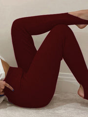 Ribbed knit stirrup leggings in wine, showing the stirrup detail and textured fabric.