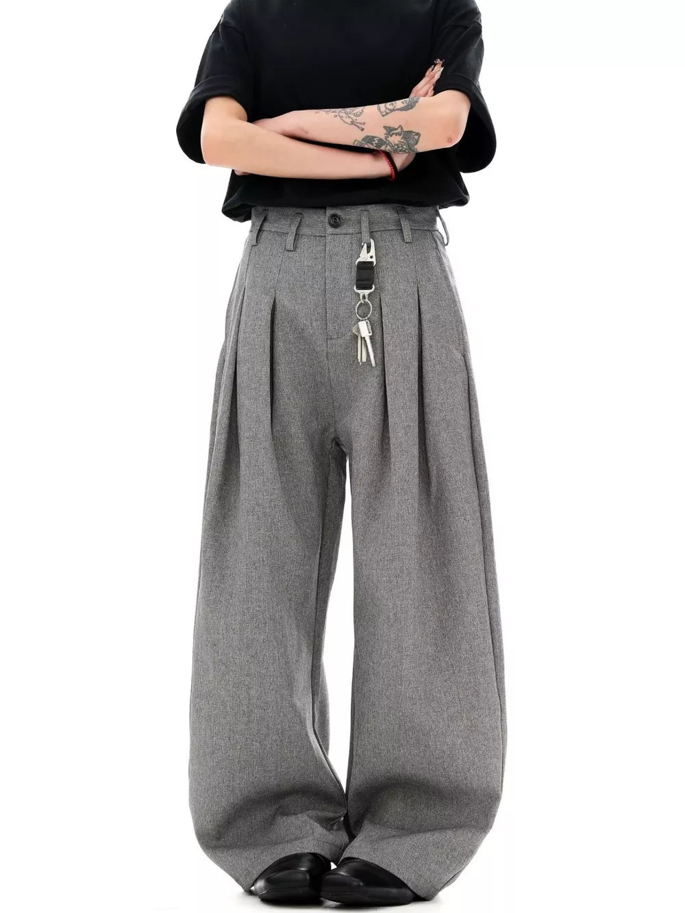 Grey wide-leg pleated sweatpants with a key chain detail.