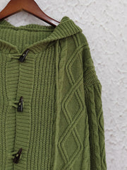Moss green cable knit hoodie with toggle buttons and diamond pattern detail.
