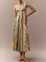 Botanical print sweetheart maxi dress with paneled skirt and white straps.