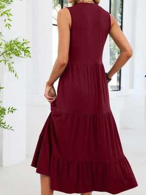 Burgundy tiered midi dress with ruffled hem and sleeveless design.
