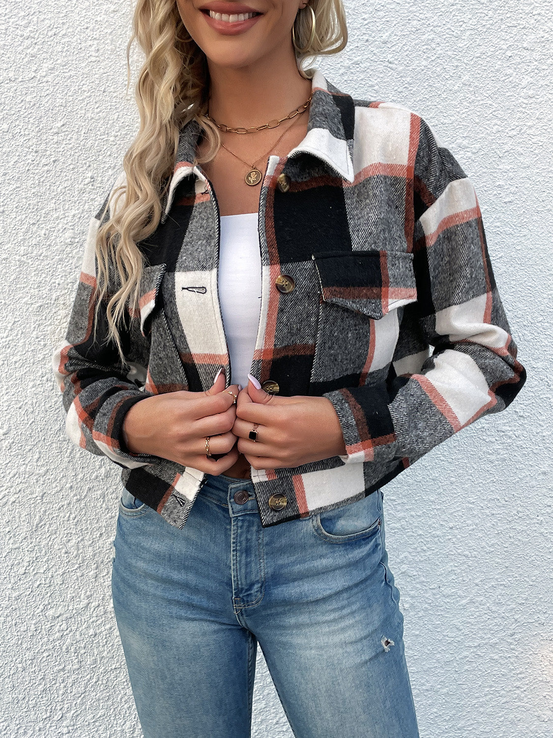 Checked plaid shacket with patch pockets in black, white, and rust.