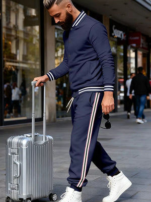 Navy striped two-piece men's track set with white trim and drawstring pants.