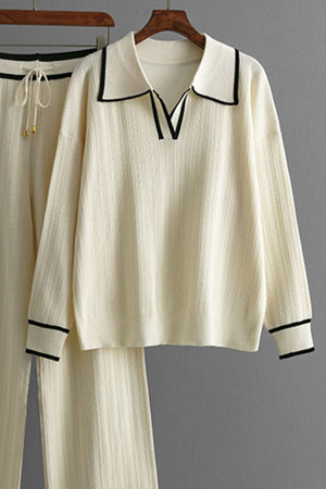 Cream ribbed knit loungewear set with contrast trim on collar and cuffs.
